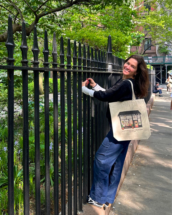 Image is of a woman walking around with one of our BCS tote bags.