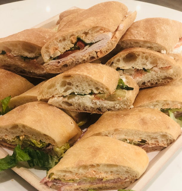 Image of the small sandwich platter. Please remember to indicate your sandwich choices in the notes section of your order (2 styles for small platters and 3 styles for large platters). Each sandwich is small/finger food sized. Small platter pricing is $108 and large platter pricing is $143 plus taxes and fees. 