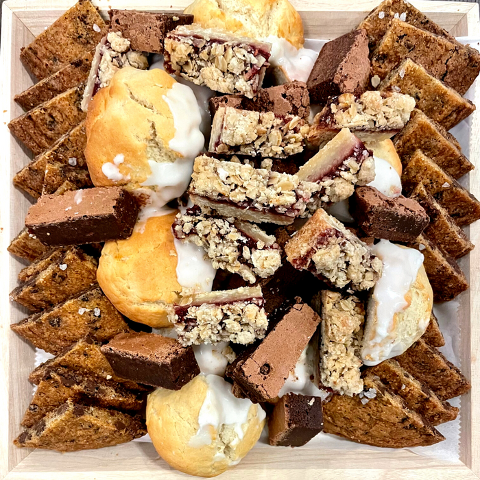 Image of our sweet treats platter containing chocolate chip cookie pieces, lemon ricotta cookie pieces, seasonal jam bars and brownies pieces. Price $105 plus taxes and fees.