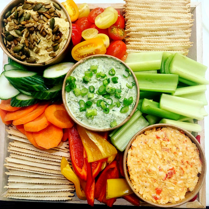 Image of our vibrant crudite platter. This is a one size fits all platter; perfect to add to your event. Comes with three dips: garlic hummus, peppaspread, and herb dip. Served with crackers, fresh seasonal veggies cut into bite sized pieces, and a fresh baguette sliced on the side. Platter pricing is $88 plus taxes and fees.